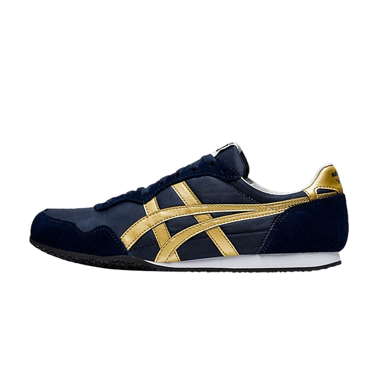 Onitsuka Tiger Serrano Midnight Pure Gold, zijaanzicht met marineblauw suède, gouden strepen en witte zool