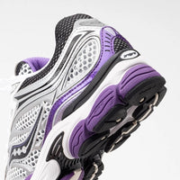 Saucony ProGrid Omni 9 White Black Silver Purple sneakers in close-up showing white black silver and purple details with textured soles and ProGrid cushioning