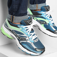 Saucony ProGrid Omni 9 Blue Lime sneakers in blue black white and lime green with mesh panels white laces and cushioned soles worn with cuffed jeans